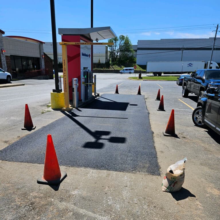 fresh pavement in front of stand alone ATM machine